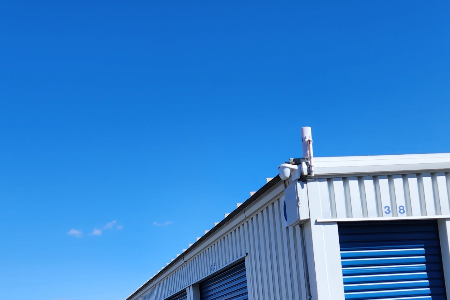 Security camera and point-to-point wireless antenna mounted on a self-storage building near Harrisburg, PA